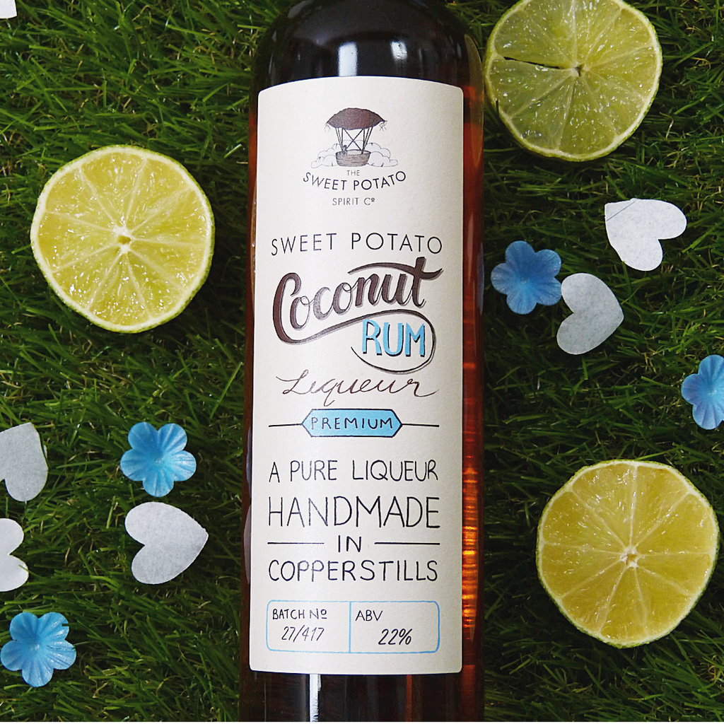 Bottle of Sweet Potato Coconut Rum Liqueur on grass with lime slices and flowers
coconut rum liqueur, coconut rum, liqueur, coconut, rum, sweet potato spirit, sweet potato, spirit, sweet, potato, drink, coconut liqueur, flavoured rum, cocktail, paradise